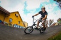 A young male riding BMX bike through a berm Royalty Free Stock Photo