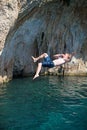 Young male rock climber jumping from a cliff Royalty Free Stock Photo