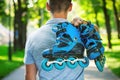Young male roller skater holding inline roller skates. Royalty Free Stock Photo