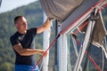 A young male sailor setting sail on his yacht. Sport. Royalty Free Stock Photo