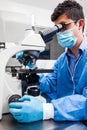 Male scientist looking at slides under the microscope Royalty Free Stock Photo
