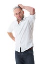 Young male scratch his head, wears white shirt Royalty Free Stock Photo
