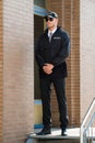Male Security Guard Standing At The Entrance Royalty Free Stock Photo