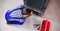 Young male serviceman working on fridge with screwdriver Royalty Free Stock Photo