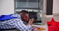 Young Male Serviceman Working On Fridge With Screwdriver Royalty Free Stock Photo