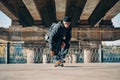 young male skateboarder in action on the street