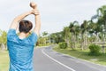 Young male stretching his arms before workout training session at the park. Healthy young man warming up outdoors. Healthy and Royalty Free Stock Photo