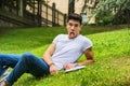 Young Male Student Doing Silly Face in City Park Royalty Free Stock Photo