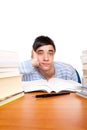 Young male student frustrated between study books Royalty Free Stock Photo