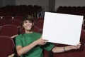 Young Male Student Holding Billboard In Classroom Royalty Free Stock Photo