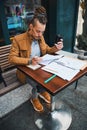 Young male student learning papers in cafe Royalty Free Stock Photo