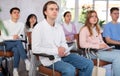 Young male student listening attentively to lecture in lecture hall Royalty Free Stock Photo