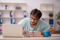 Young male student preparing for exams in the classroom Royalty Free Stock Photo