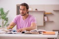 Young male student preparing for exams at home Royalty Free Stock Photo