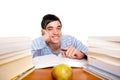 Young male student sitting between study books Royalty Free Stock Photo