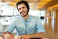 Young male student studying in the library