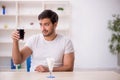 Young male student testing soft drink