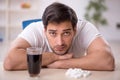 Young male student testing soft drink