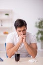 Young male student testing soft drink