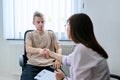 Young male student at therapy meeting with college psychologist counselor Royalty Free Stock Photo