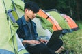 Young man laptop coffee camping tent Royalty Free Stock Photo