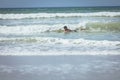 Young male surfer enjoying surfing at beach