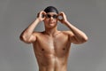 Young male swimmer preparing for the start, close-up portrait of a swimmer in a mask and a hat, gray background, copy Royalty Free Stock Photo