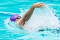 Young male swimmer swims in back stroke