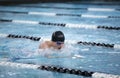 Young male swimmer swims the breaststroke in a competition