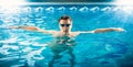 Young male swimmer taking a breath and relaxing at pool