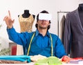 Young male tailor working at workshop Royalty Free Stock Photo