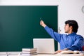The young male teacher in front of chalkboard Royalty Free Stock Photo