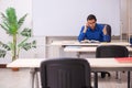 Young male teacher in front of whiteboard