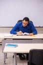 Young male teacher in front of whiteboard