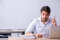 Young male teacher in front of whiteboard