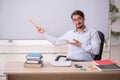 Young male teacher in front of whiteboard