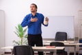 Young male teacher in remuneration concept Royalty Free Stock Photo