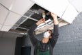 Young male technician cleaning air conditioner