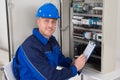 Young Male Technician Examining Fusebox Royalty Free Stock Photo