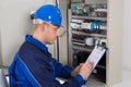 Young Male Technician Examining Fusebox Royalty Free Stock Photo