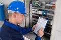 Young Male Technician Examining Fusebox Royalty Free Stock Photo