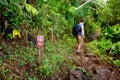 Young male tourist hiking on the famous Kalalau trail along Na Pali coast of the island of Kauai Royalty Free Stock Photo