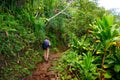 Young male tourist hiking on the famous Kalalau trail along Na Pali coast of the island of Kauai Royalty Free Stock Photo