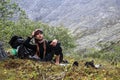 Young male tourist sat down to rest in a mountain hike Royalty Free Stock Photo