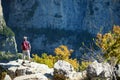 Young male tourist at Vikos Gorge, a gorge in the Pindus Mountains of northern Greece, lying on the southern slopes of Mount Tymfi Royalty Free Stock Photo