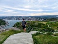 A young male tourist walking up signal hill towards cabot tower. A famous landmark in St. Johns, Newfoundland, Canada.