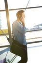 Young male traveler walking with bags at airport Royalty Free Stock Photo