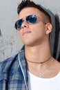 Young male urban fashion sky on sunglasses