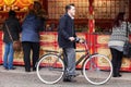 A young male on a vintage bicycle and dressed in vintage clothing