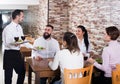 Waiter bringing order to visitors Royalty Free Stock Photo